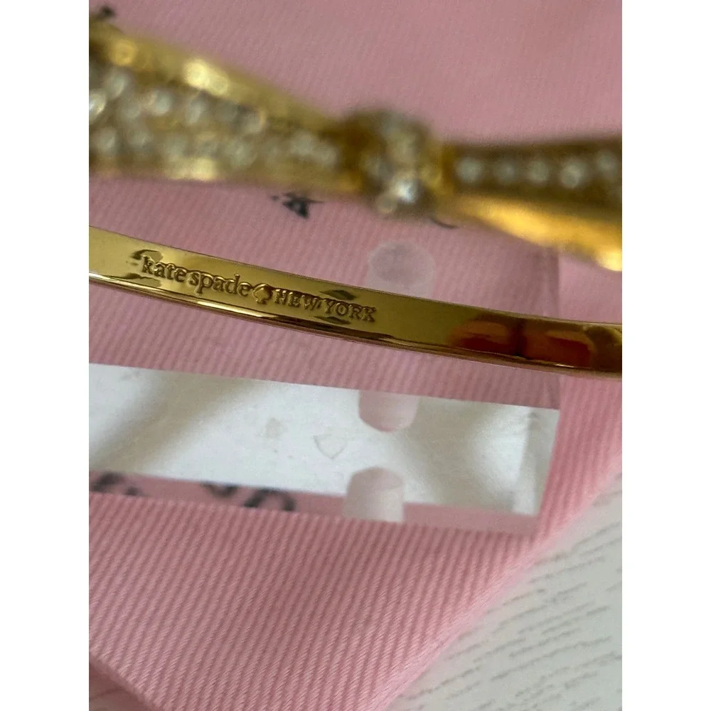 Kate Spade New York Gold Tone Pave Crystal Bow Hinged Bangle Bracelet with Bag